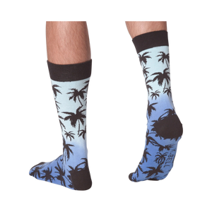 Back view of Palm Socks on a person's legs against a black background.