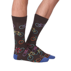 Lifestyle shot of male model wearing the Bright Bikes socks, showcasing how they look when worn.