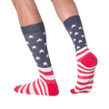 Lifestyle shot of a person wearing the American flag socks. The socks are visible from the ankles down, showcasing the design.