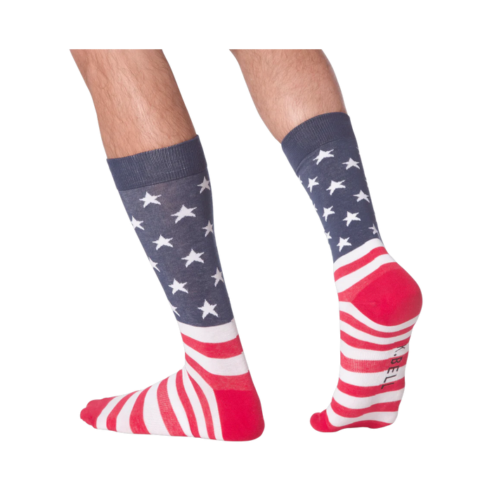 Lifestyle shot of a person wearing the American flag socks. The socks are visible from the ankles down, showcasing the design.