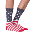 Another lifestyle shot of a pair of American flag socks on a person's legs.