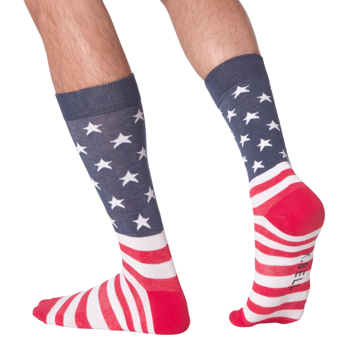 A pair of calf-length socks with an American flag pattern. The socks are blue with white stars and red and white stripes.