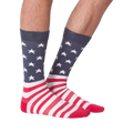 Close-up view of a pair of American Flag XL socks on a person's feet; showcasing a front view against a black background.