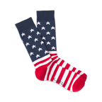 Pair of red, white, and blue crew socks. The top features a navy blue background with white stars; the bottom has red and white stripes. 'K.Bell' is subtly visible on the heel.