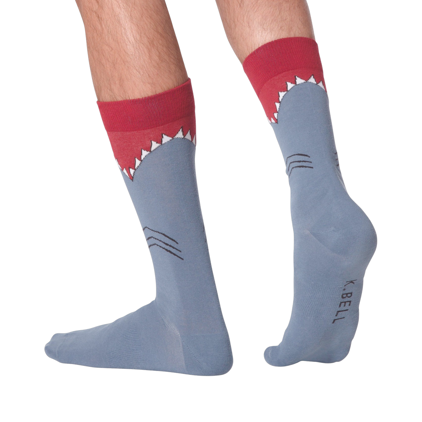 Lifestyle shot showing Shark XL socks on a person's legs. Socks are blue with a shark design.