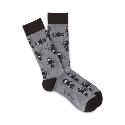 Pair of gray crew socks with a repeating pattern of black cartoon ninjas.  Ninjas are depicted in various playful poses.