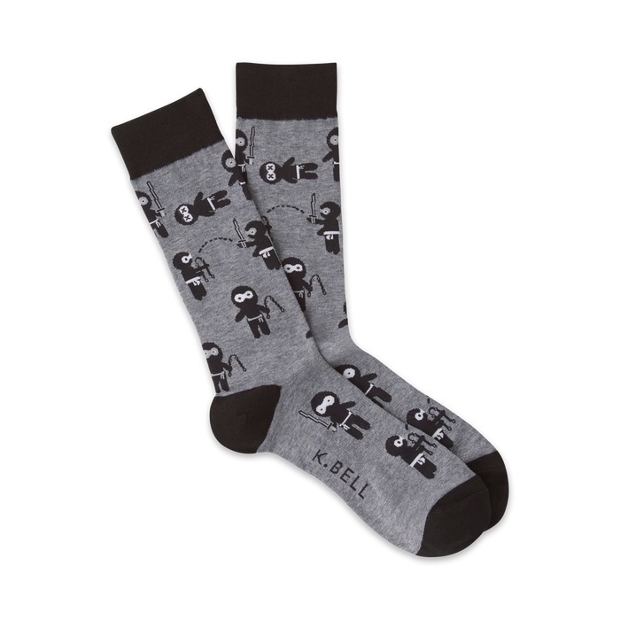 gray crew socks with a pattern of black ninjas in various poses, throwing stars, swinging swords, and jumping.   }}