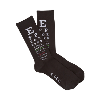 A pair of dark brown crew socks with a white eye chart pattern printed on them. The text includes letters and symbols typical of eye exams. 'K.BELL' is visible on the bottom.