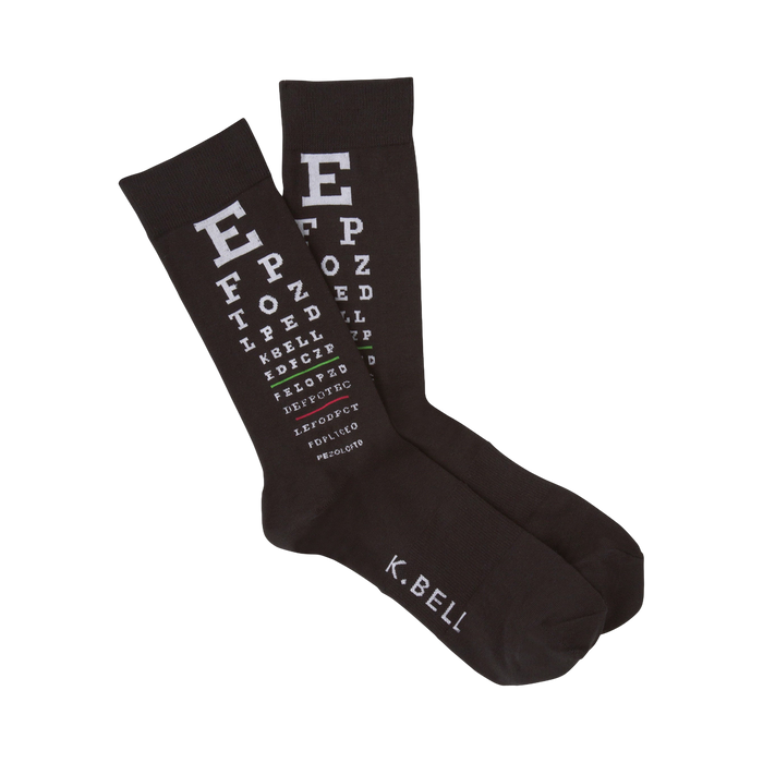 A pair of dark brown crew socks with a white eye chart pattern printed on them. The text includes letters and symbols typical of eye exams. 'K.BELL' is visible on the bottom. }}