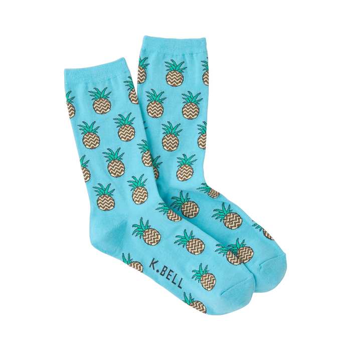 Pair of light blue crew socks with a repeating pattern of brown and green zig-zag pineapples. }}