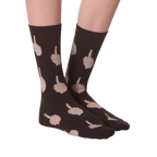 Close-up of a model's legs wearing pink 'Middle Finger' socks.