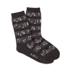 Pair of crew socks in dark grey and white with a musical notes design.  The socks show a repeating pattern of musical notes on a staff.