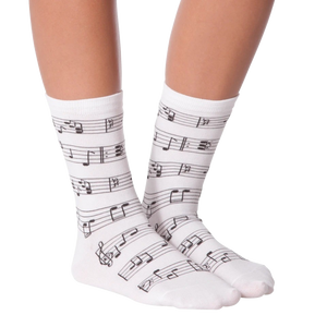 A pair of white socks with black musical notes.