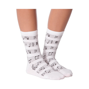 Lifestyle shot of model wearing white musical note socks.