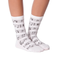 Lifestyle shot of model wearing white musical note socks.