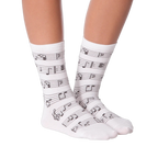 Lifestyle shot of model wearing white musical note socks.