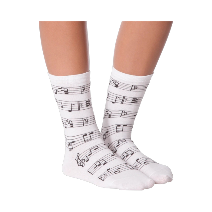Lifestyle shot of model wearing white musical note socks.