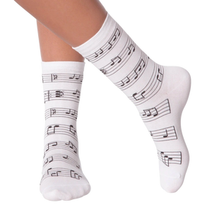 A pair of white socks with black musical notes.