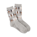 Pair of grey crew socks featuring a repeating pattern of cats sitting on a fence. 