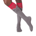 Lifestyle shot showing a person wearing the gray and red shark knee-high socks.