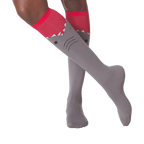 Lifestyle shot showing a person wearing the gray and red shark knee-high socks.