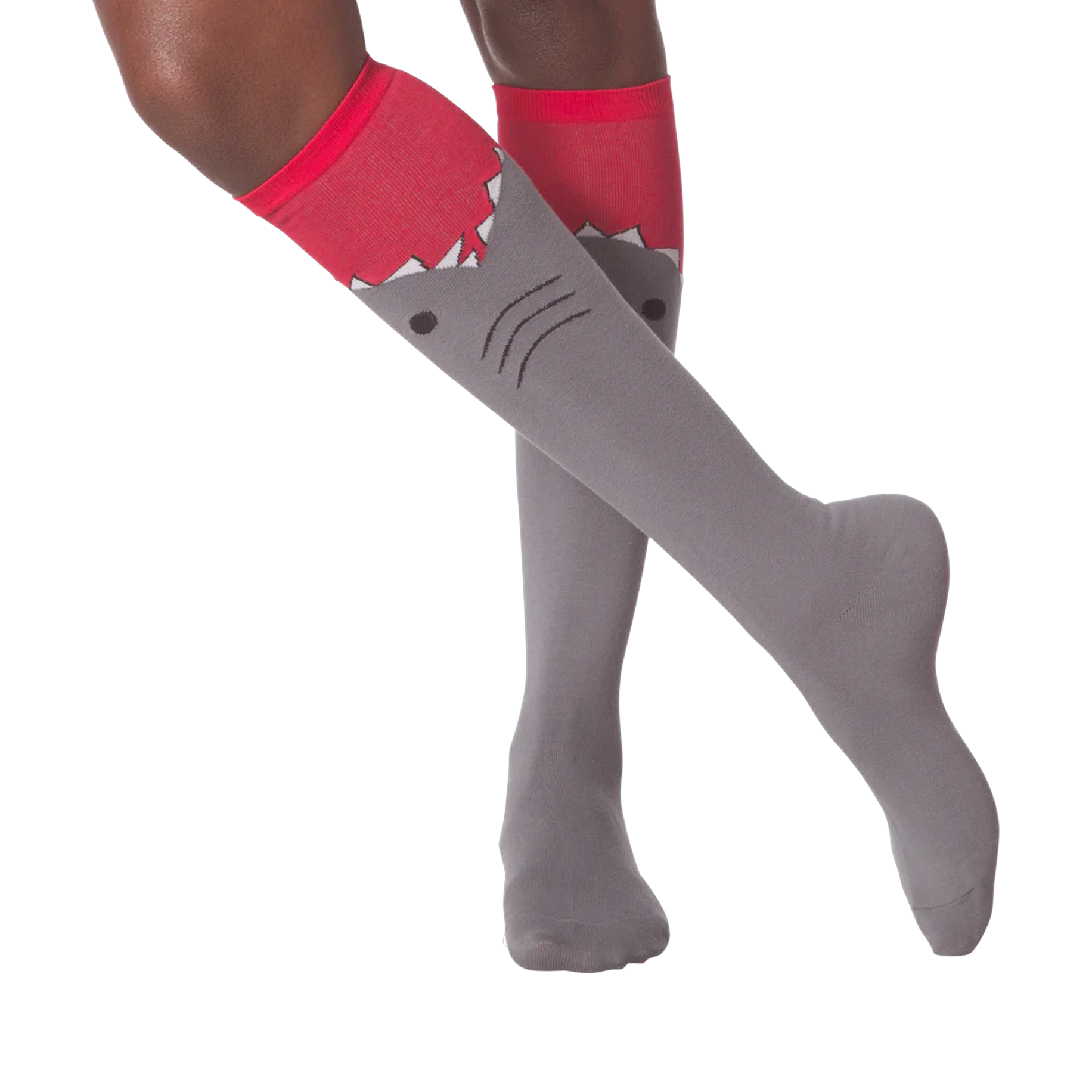 Lifestyle shot showing a person wearing the gray and red shark knee-high socks.