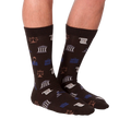 Lifestyle shot: A model is wearing the dark brown Lawyer socks, showcasing how they look on feet.