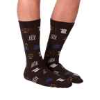 Lifestyle shot: A model is wearing the dark brown Lawyer socks, showcasing how they look on feet.
