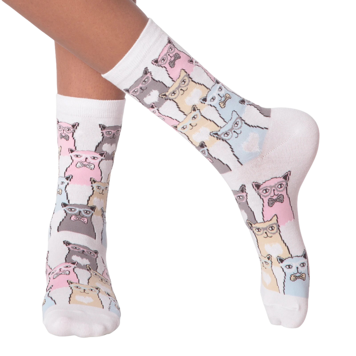 Close-up of a person's legs wearing white Smarty Cats socks.