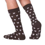 Lifestyle shot showing the socks on a person's feet.  The socks are dark brown with a tooth pattern. The image is on a black background.