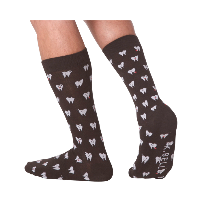 Lifestyle shot showing the socks on a person's feet.  The socks are dark brown with a tooth pattern. The image is on a black background.