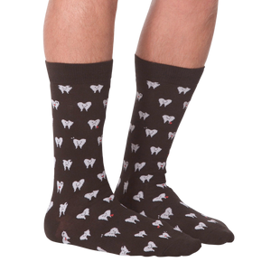A pair of brown socks with a pattern of white teeth with red hearts on them.