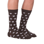 Another lifestyle shot showing the socks on a person's feet, this time from the front.  The socks are dark brown with a tooth pattern. The image is on a black background.