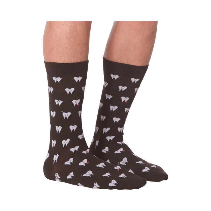 Another lifestyle shot showing the socks on a person's feet, this time from the front.  The socks are dark brown with a tooth pattern. The image is on a black background.