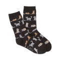 A pair of dark-grey crew socks with a repeating pattern of light-grey, orange, and white cats in various poses.