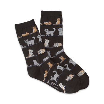 black socks with pattern of orange, gray, and white cats in different poses including sitting, standing, and laying down.   