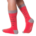 Lifestyle shot of a model wearing a pair of red 'Talk Nerdy To Me' socks.