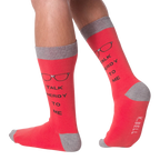 Lifestyle shot of a model wearing a pair of red 'Talk Nerdy To Me' socks.