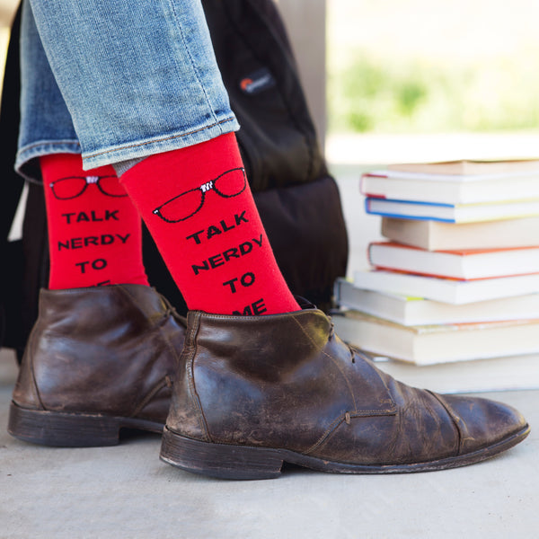 Close-up of the 'Talk Nerdy To Me' socks against a black background. [lf]