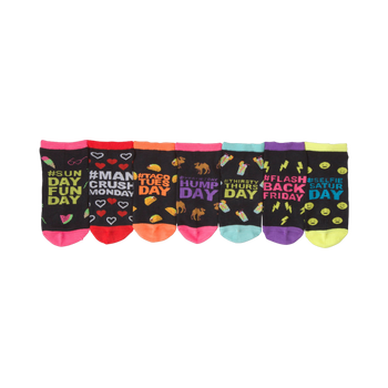 Seven pairs of ankle socks. Each black sock has a different day-of-the-week design with bright accents. Designs include watermelon, hearts, tacos, camels, and cocktails.