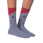 Flatlay showcasing a pair of blue crew socks with a shark face design.