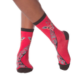 Lifestyle shot of model wearing red crew socks with a giraffe wearing glasses design.