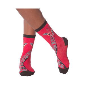 Lifestyle shot of model wearing red crew socks with a giraffe wearing glasses design.