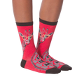 Another lifestyle shot of model wearing red crew socks with a giraffe wearing glasses design.