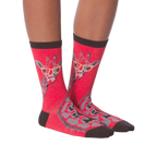 Another lifestyle shot of model wearing red crew socks with a giraffe wearing glasses design.