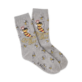 A pair of grey crew socks with a fun design.  The main image is a crowned bee with the words 'Queen Bee' repeated throughout.  Smaller bees are scattered on the socks as well.