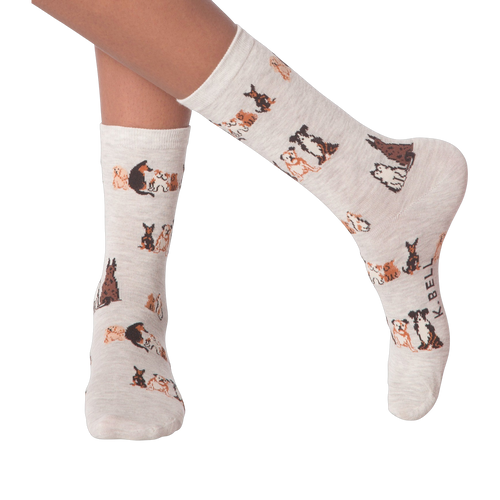 Lifestyle shot of woman's legs wearing the grey crew socks with the dog pattern.