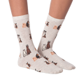 Close-up studio shot of a pair of the grey crew socks; showcasing the dog pattern.