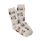Pair of grey crew socks with a repeating pattern of brown and black illustrated dogs sitting down.