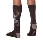 Back view of a person wearing a pair of 'Buck You' socks.